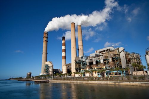 Power generation plant with smokestack and blue sky