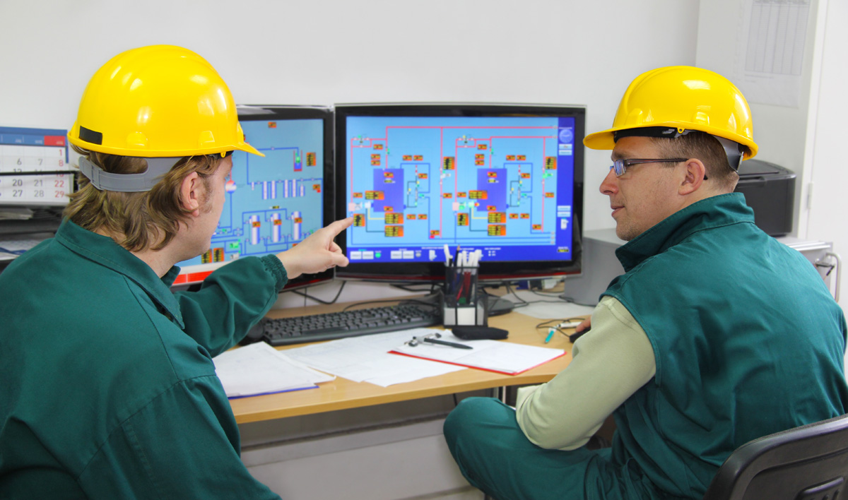 Workers in control room engaged in power plant operator training