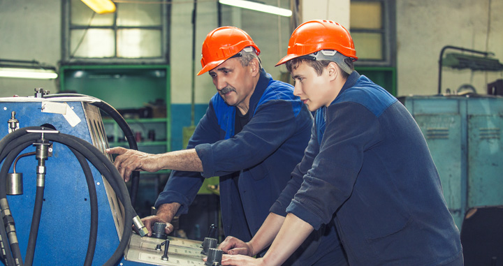 Older worker teaching younger worker as part of a Power Plant Training Program